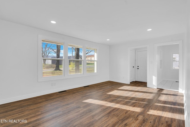 unfurnished room featuring dark hardwood / wood-style floors