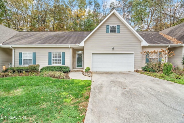 view of front of home with a garage and a front lawn