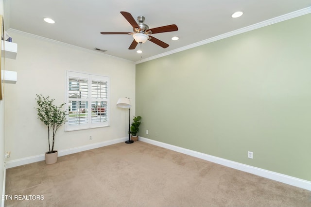 unfurnished room featuring light colored carpet, ceiling fan, and ornamental molding