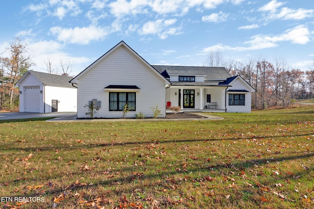 modern inspired farmhouse with a garage and a front lawn