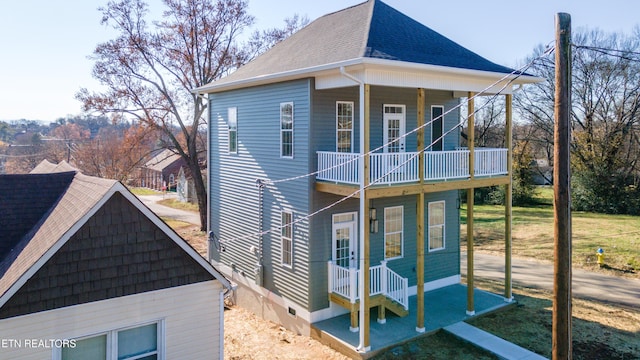 view of side of home with a balcony