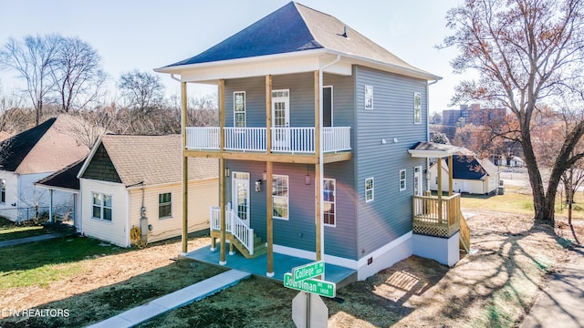 back of property featuring a yard and a balcony