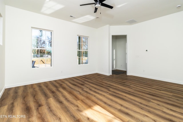 empty room featuring ceiling fan and dark wood-type flooring