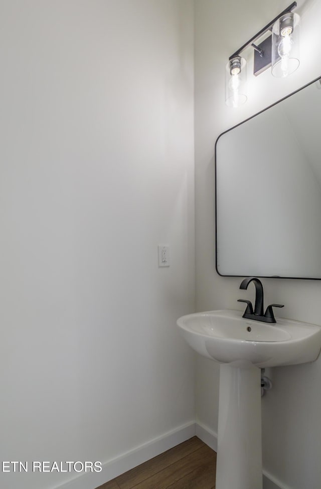 bathroom with hardwood / wood-style floors and sink