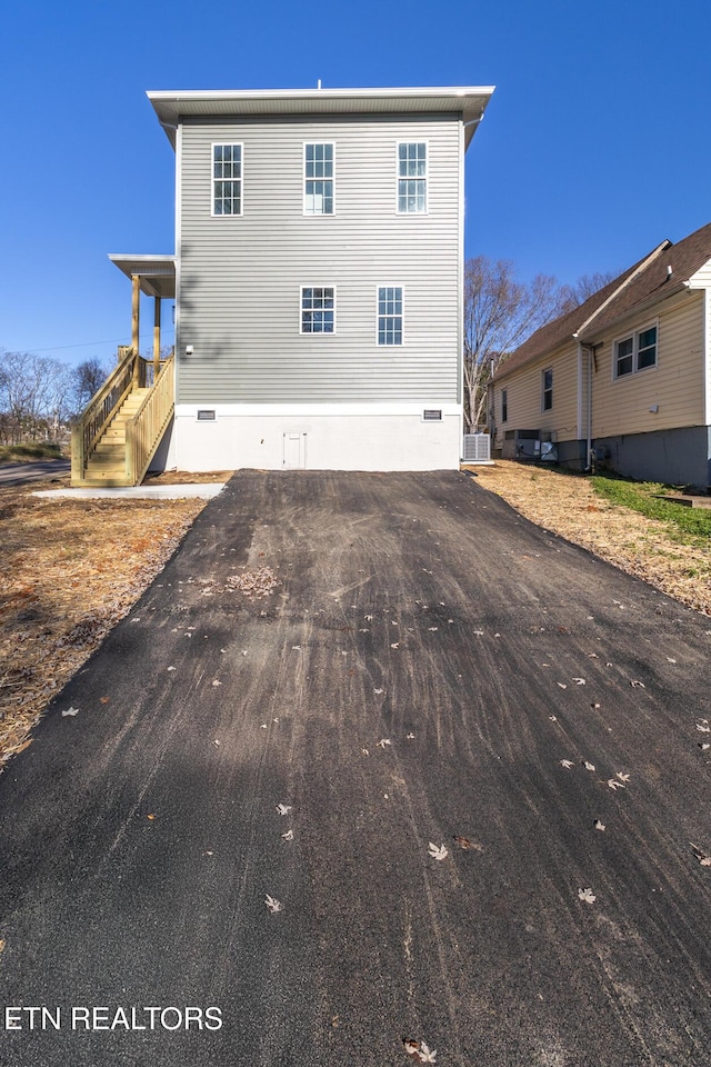 rear view of property with central AC