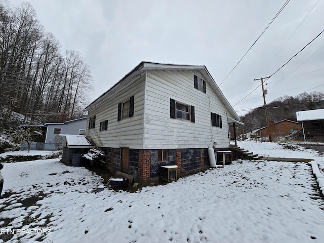 view of snowy exterior with central AC