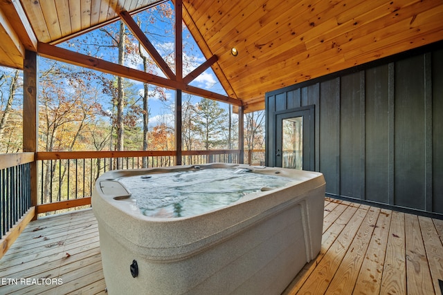 wooden deck with a hot tub