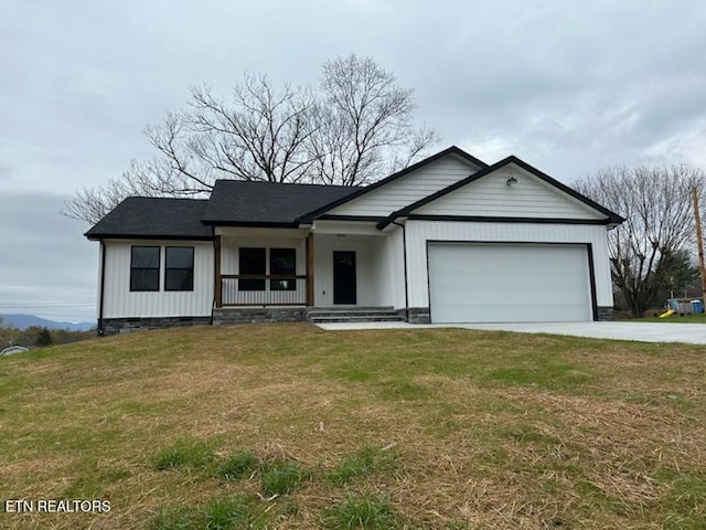 ranch-style house with a front lawn, covered porch, and a garage