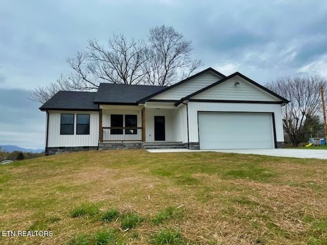 ranch-style home with a porch, a front yard, and a garage