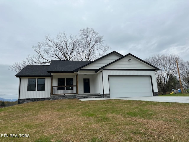 single story home featuring a front lawn, covered porch, and a garage