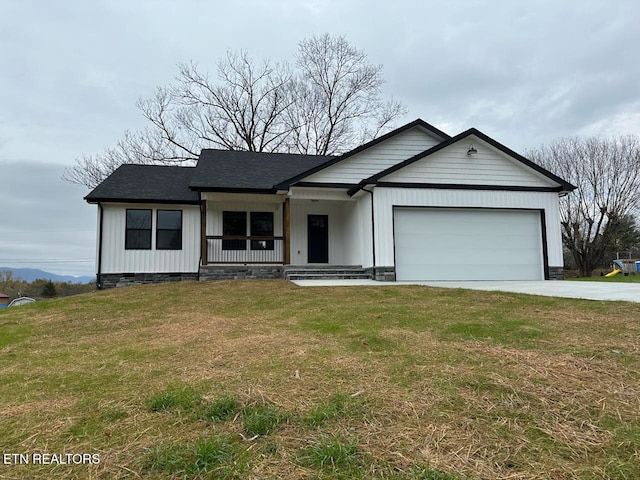 single story home featuring covered porch, a garage, and a front lawn