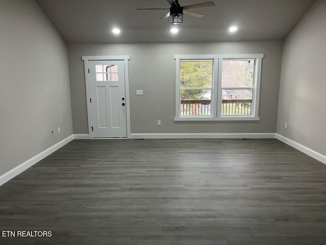 foyer entrance featuring ceiling fan and dark wood-type flooring