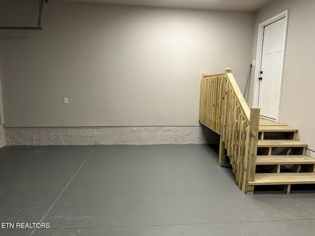 staircase featuring concrete floors