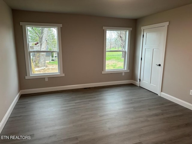 unfurnished room featuring dark wood-type flooring