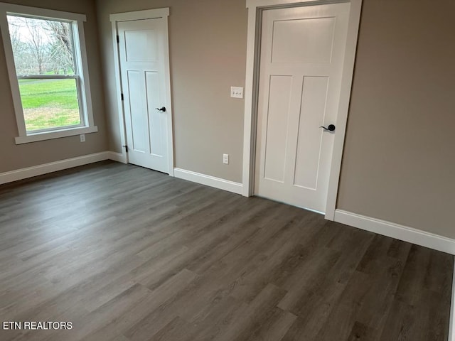 unfurnished bedroom featuring dark hardwood / wood-style floors