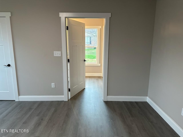 spare room with dark hardwood / wood-style flooring