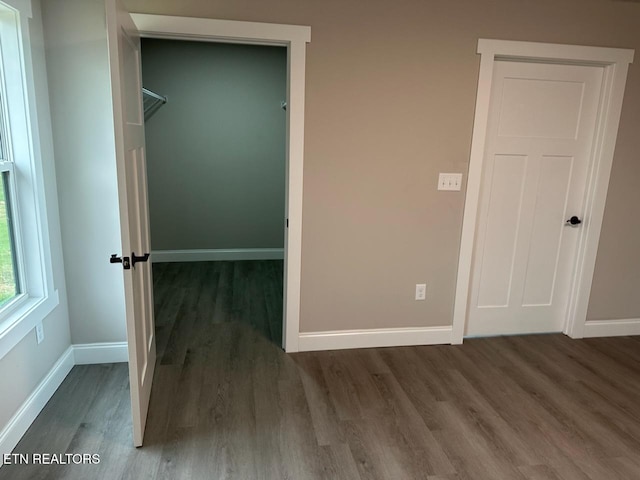 unfurnished bedroom with a closet and hardwood / wood-style floors