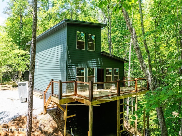 back of property featuring a wooden deck