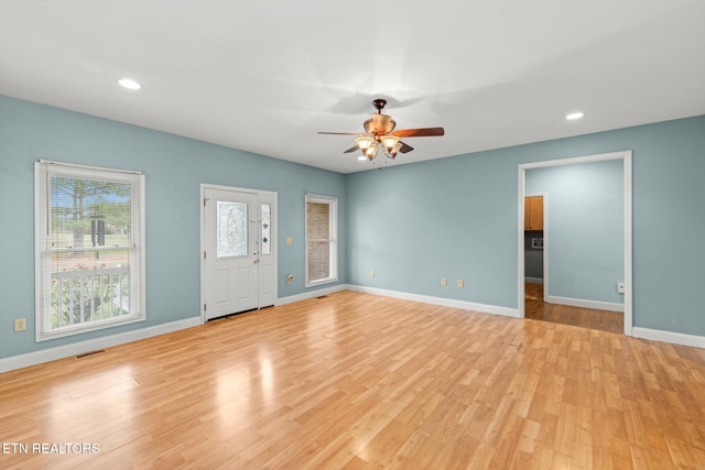 unfurnished living room featuring ceiling fan and light hardwood / wood-style flooring