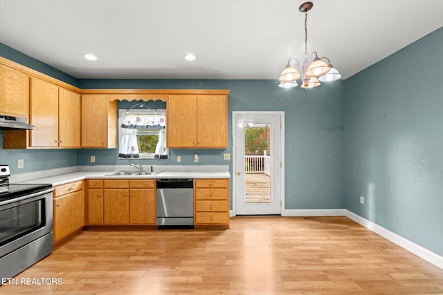 kitchen with stainless steel appliances, extractor fan, sink, decorative light fixtures, and light hardwood / wood-style flooring