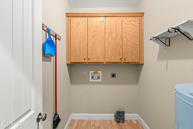 washroom with electric dryer hookup, cabinets, hookup for a washing machine, and light hardwood / wood-style flooring