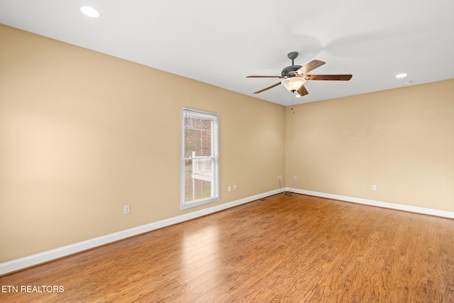 empty room featuring ceiling fan and light hardwood / wood-style flooring