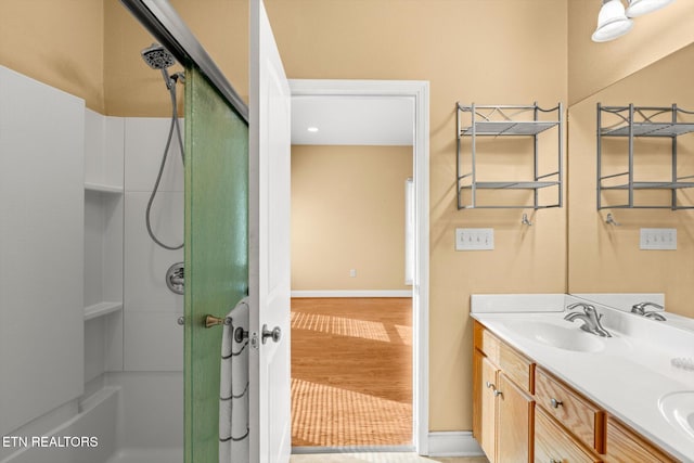 bathroom with a shower, wood-type flooring, and vanity