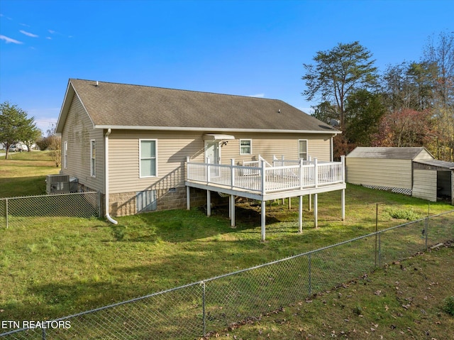 rear view of property featuring central AC, a yard, and a deck