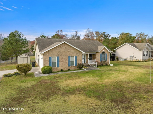 view of front facade featuring a front yard, a porch, a garage, and an outdoor structure