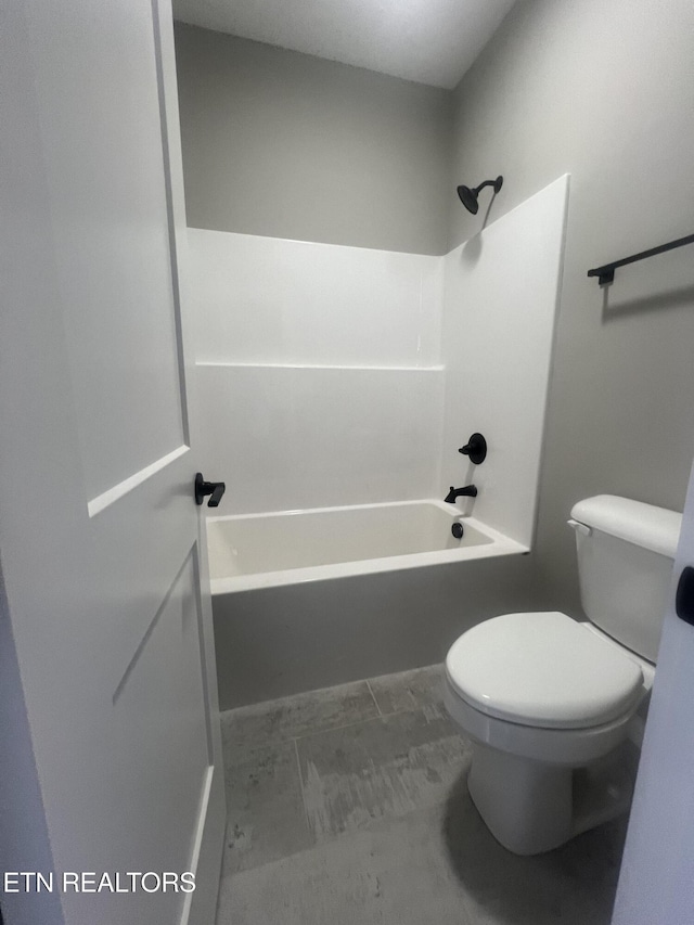 bathroom featuring washtub / shower combination and toilet