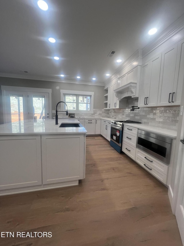 kitchen with light countertops, white cabinetry, stainless steel range with gas cooktop, and open shelves