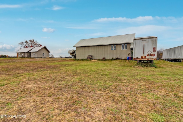 exterior space featuring a lawn and an outbuilding