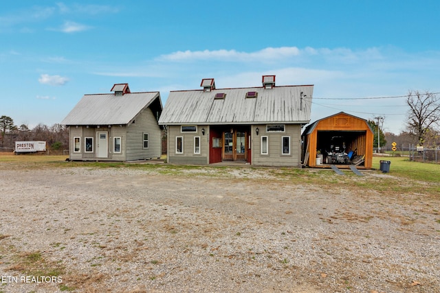 rear view of house with an outdoor structure