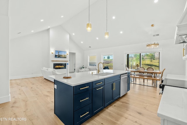 kitchen featuring a center island with sink, dishwasher, light wood-type flooring, and sink