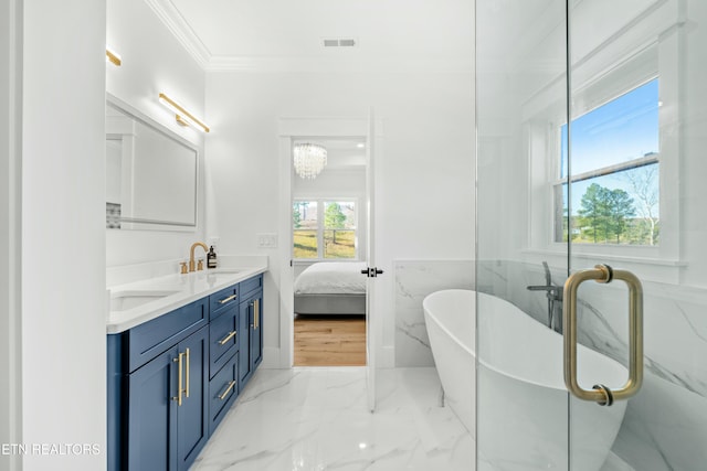 bathroom featuring a washtub, vanity, tile walls, and crown molding