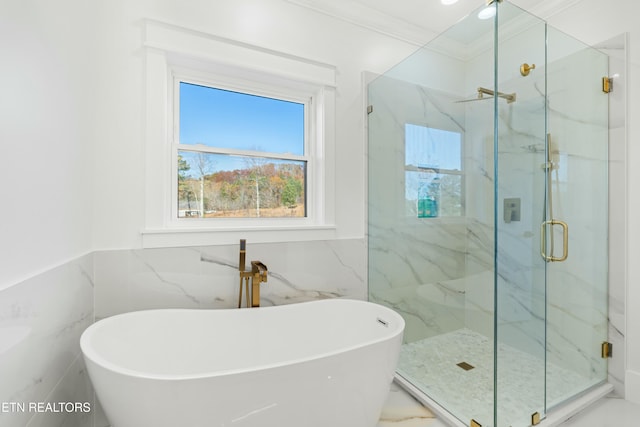 bathroom featuring separate shower and tub, tile walls, and ornamental molding