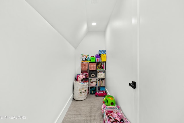 rec room featuring carpet flooring and vaulted ceiling