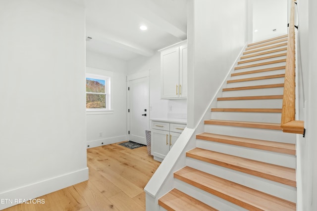 stairs featuring hardwood / wood-style flooring