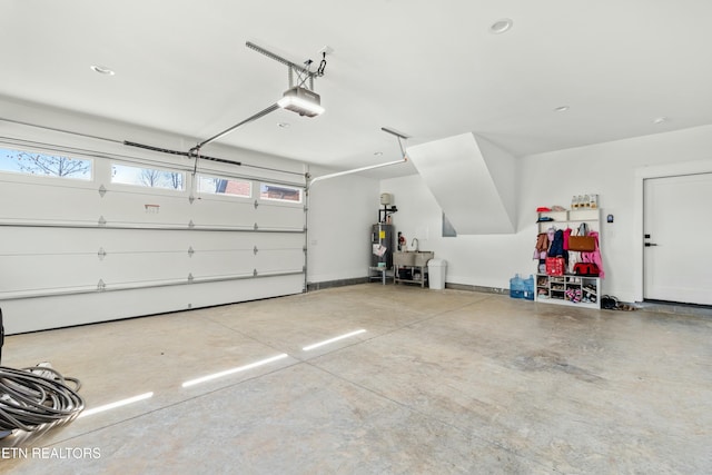 garage featuring electric water heater and a garage door opener