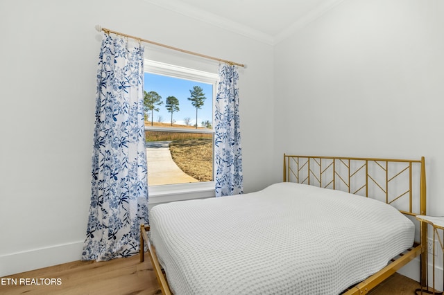 bedroom featuring hardwood / wood-style flooring and crown molding