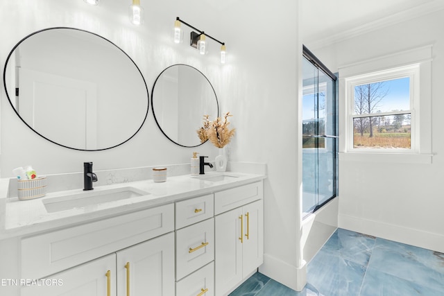 bathroom featuring vanity, shower / bath combination with glass door, and ornamental molding