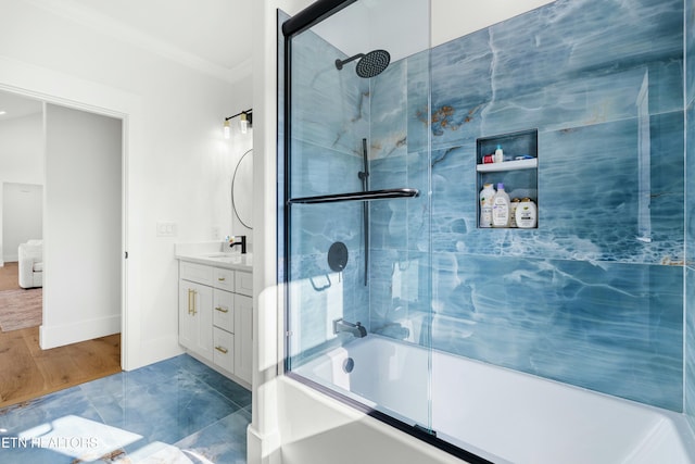 bathroom with hardwood / wood-style floors, vanity, shower / bath combination with glass door, and crown molding