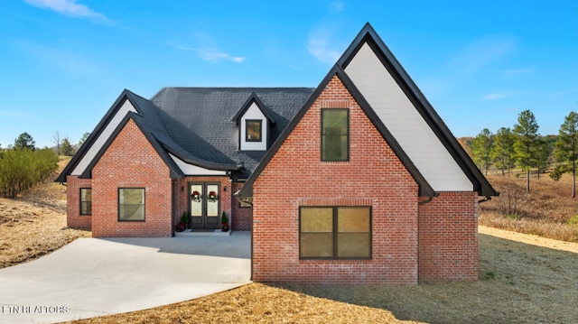 tudor home featuring french doors