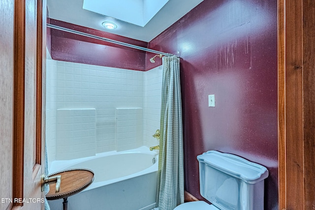 bathroom featuring shower / tub combo, a skylight, and toilet