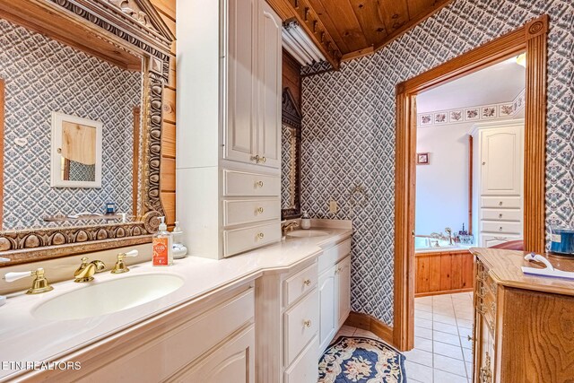 bathroom featuring tile patterned floors, vanity, a bathing tub, and wooden ceiling