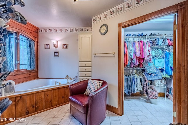 bathroom with tile patterned flooring and a tub