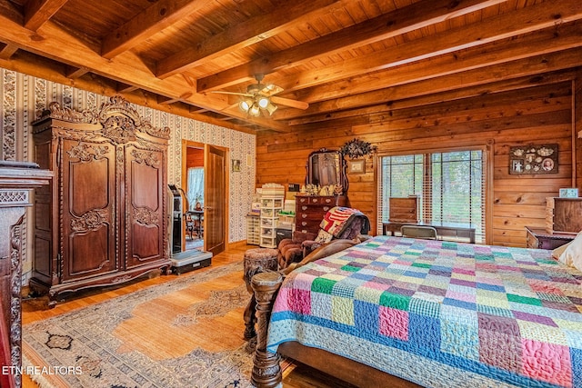 bedroom featuring hardwood / wood-style floors, ceiling fan, wood walls, and beamed ceiling