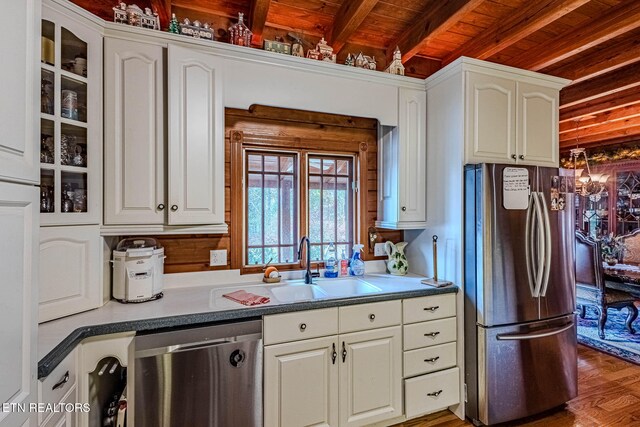 kitchen featuring beamed ceiling, white cabinets, wood ceiling, and appliances with stainless steel finishes