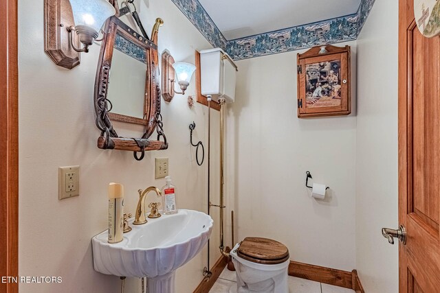 bathroom with tile patterned flooring, toilet, and sink