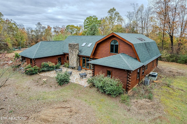 view of front facade with cooling unit and a patio